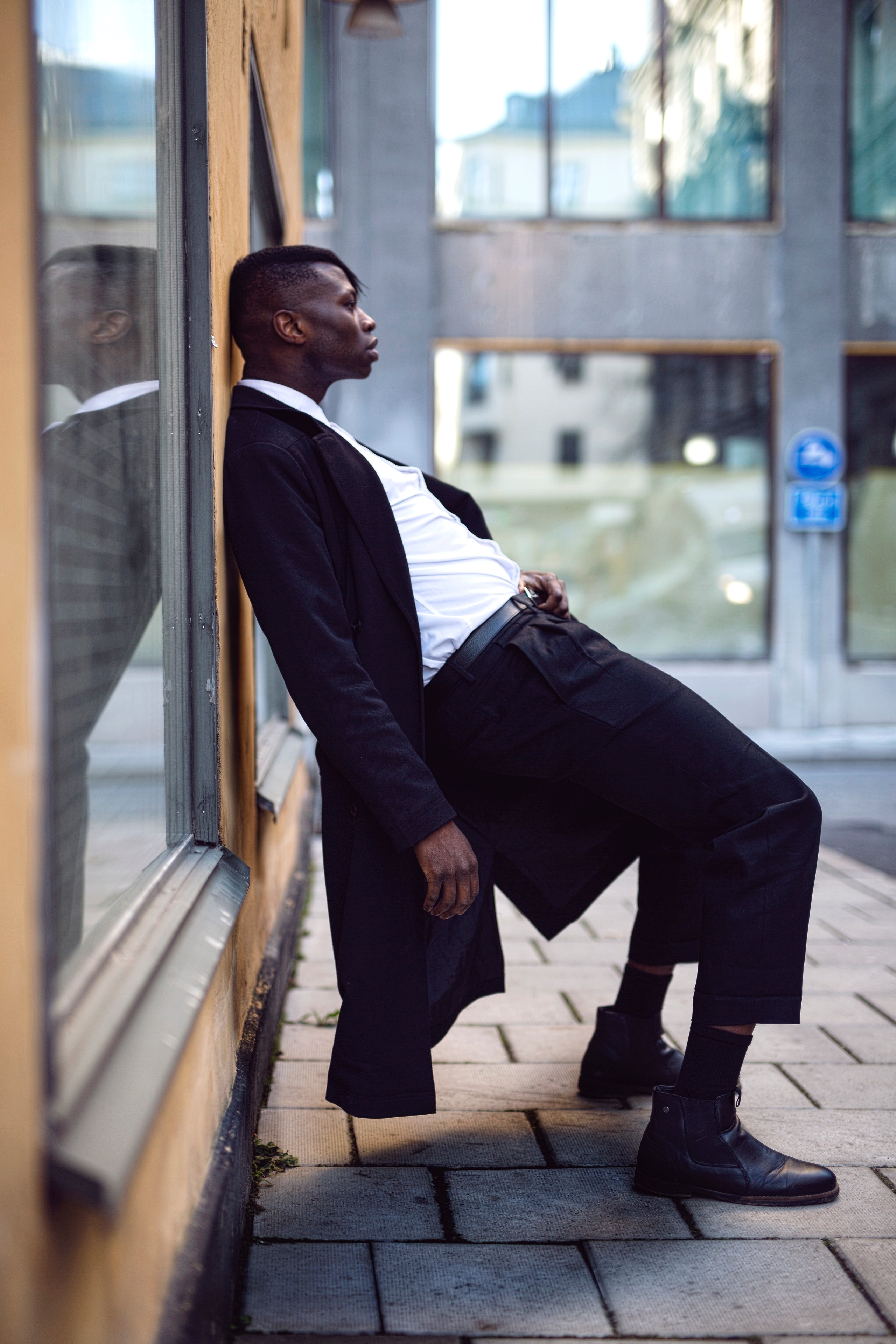 Man in suit leaning against wall