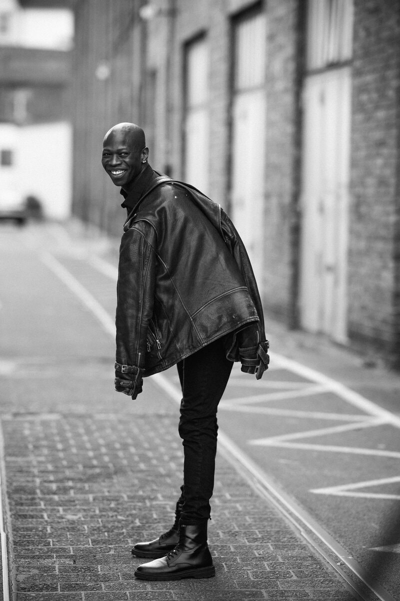 Man in leather jacket urban alley