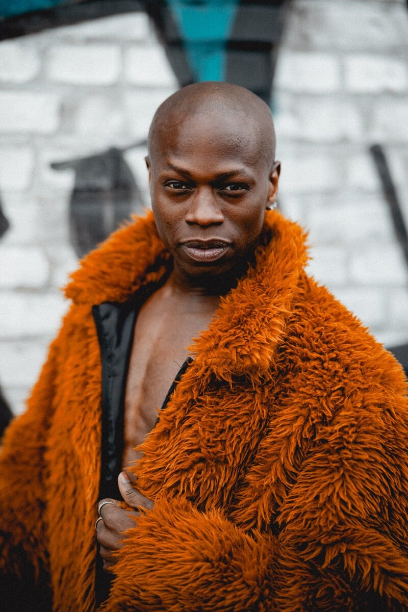 Man in bright orange fuzzy coat