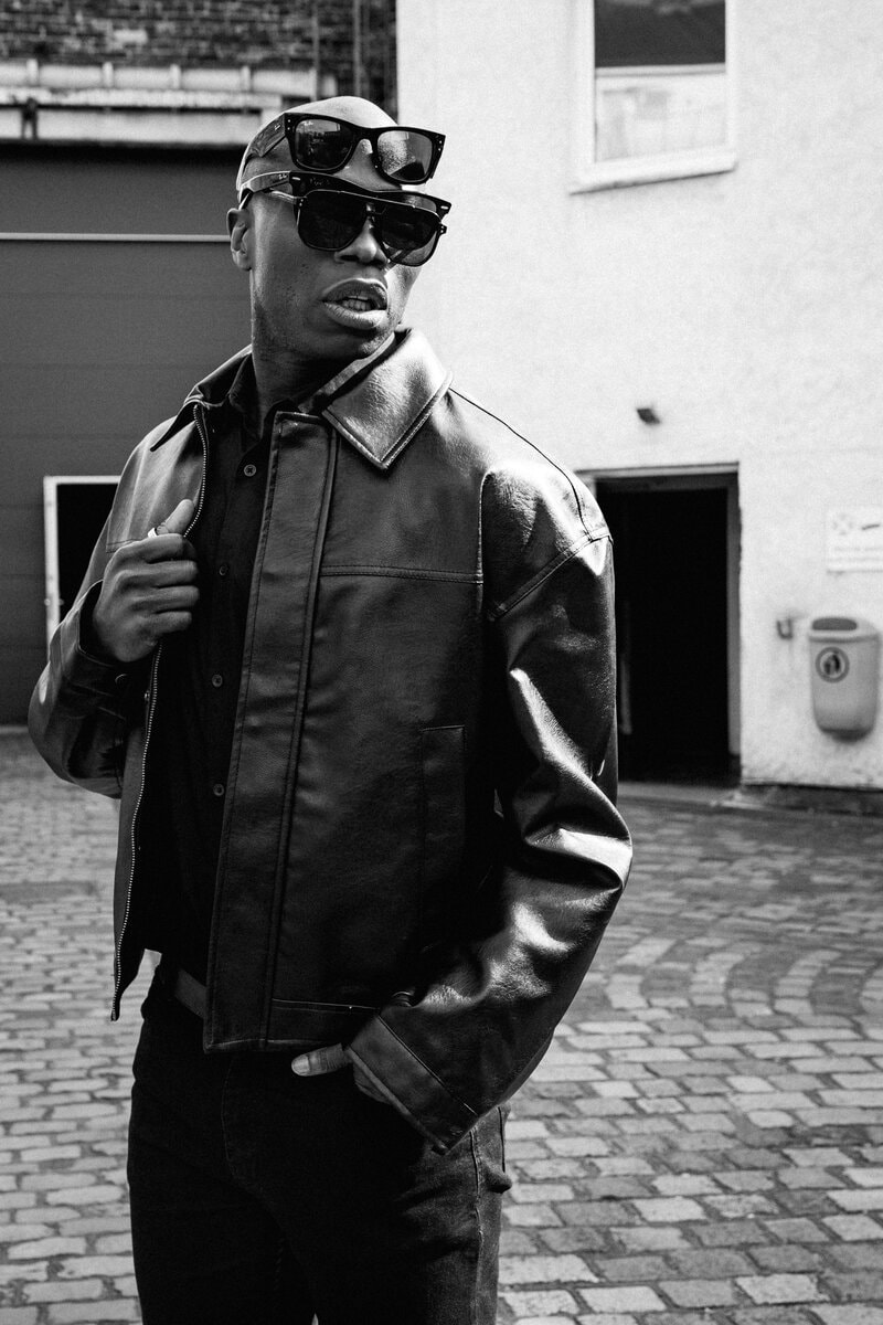 Black and white leather jacket sunglasses courtyard