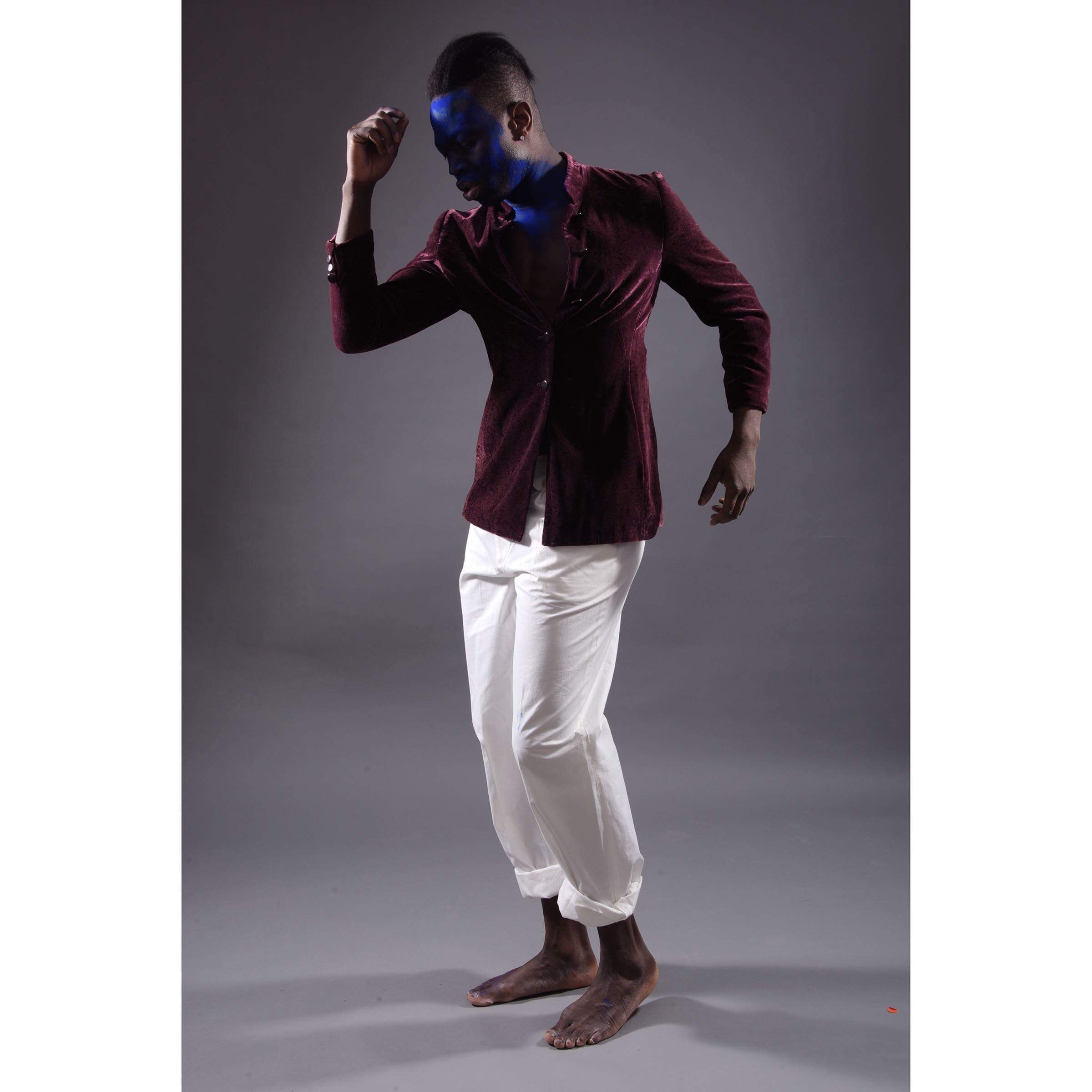 Man with blue face paint dancing pose