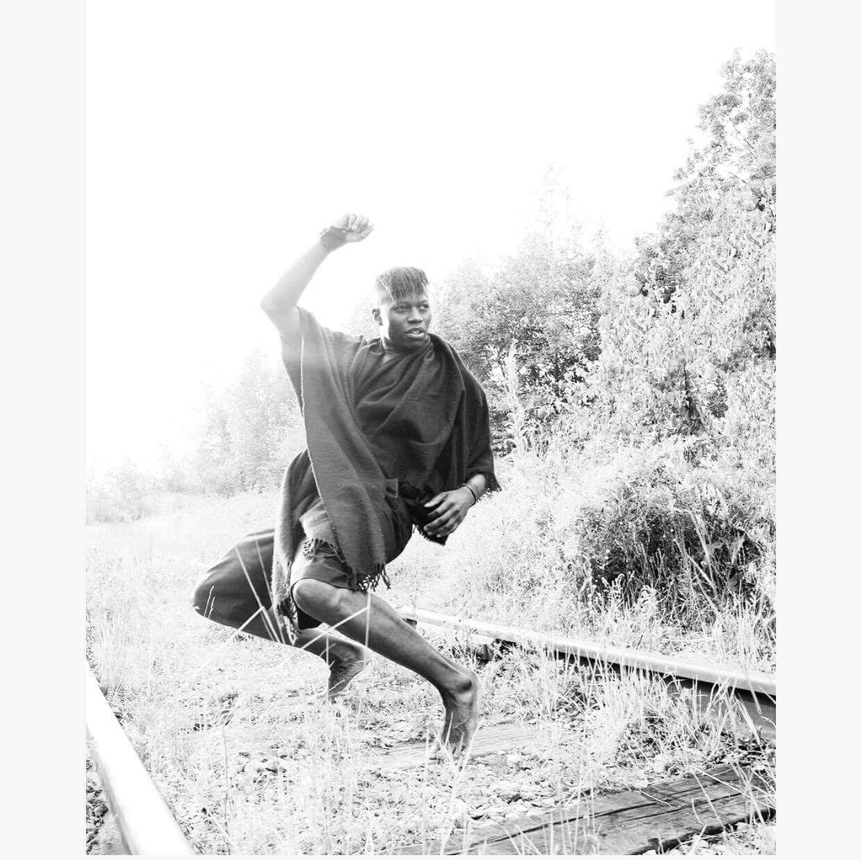 Man jumping over railroad tracks