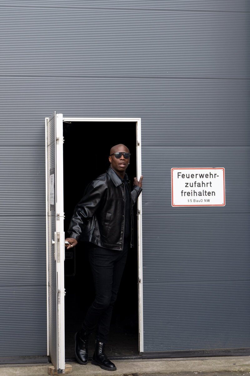 Man in grey coat with aviator sunglasses