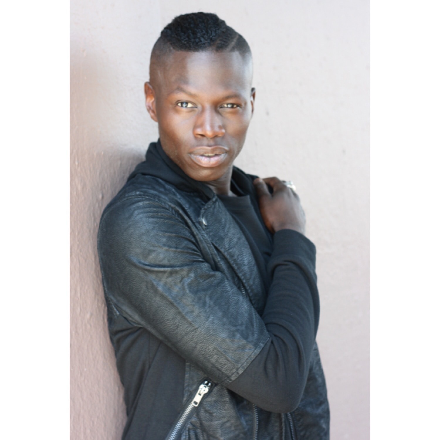 Portrait in black shirt against concrete wall