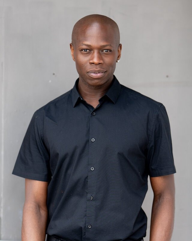 Man in black shirt against grey wall