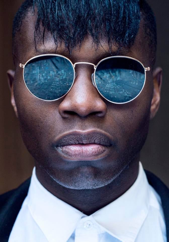 Man with round blue sunglasses